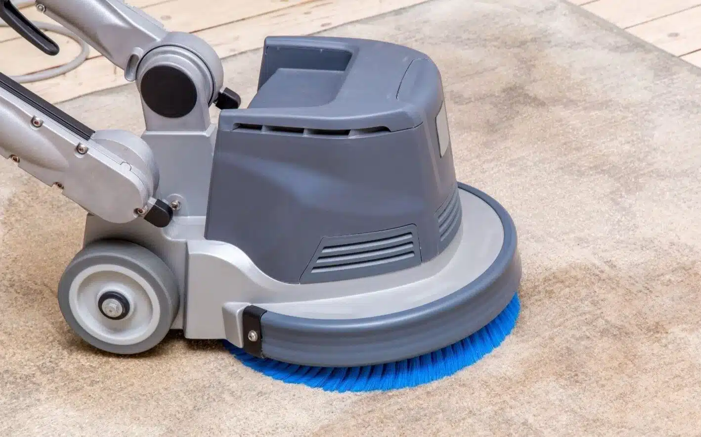 Rotary machine cleaning a hard floor and grout lines